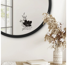 Miroir rond avec motif floral, vase avec fleurs séchées et livres sur une table