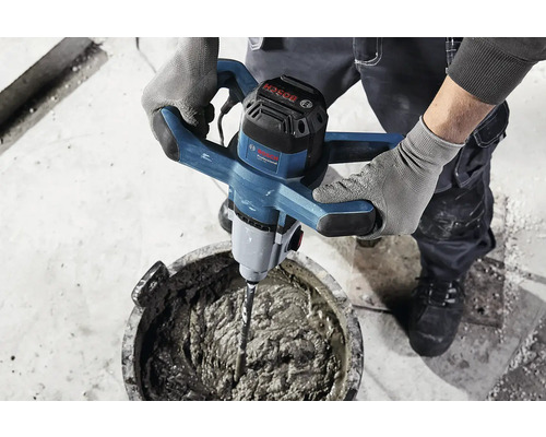 Un artisan mélange du mortier avec un mélangeur électrique à mortier de Bosch.