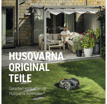 Husqvarna Automower auf Rasen vor einem Haus mit Terrasse und Person.