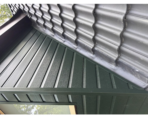 Gros plan d''un toit avec des tuiles et des panneaux de bois verticaux.