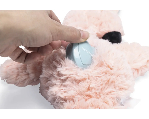 Hand legt ein elektronisches Gerät in ein Plüschtier