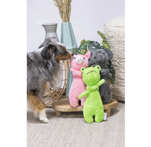 Hund mit Stofftieren Frosch, Schwein und Koala auf einem kleinen Tisch