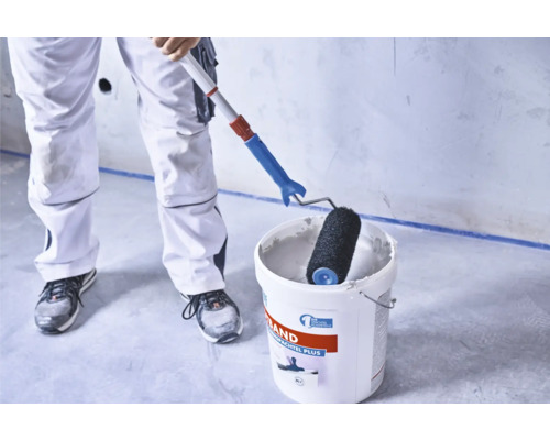 Peintre avec rouleau à peinture et seau d'enduit