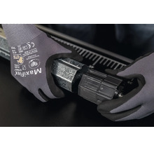 Hände mit Schutzhandschuhen montieren einen Rolladenkasten