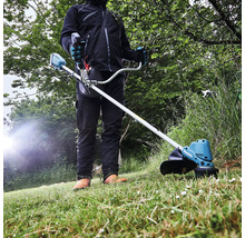 Une personne utilise un coupe-bordures à batterie Makita dans le jardin.