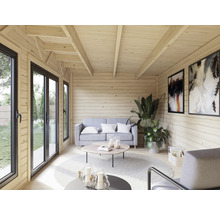 Intérieur clair d'une maison en bois avec canapé, table et décoration
