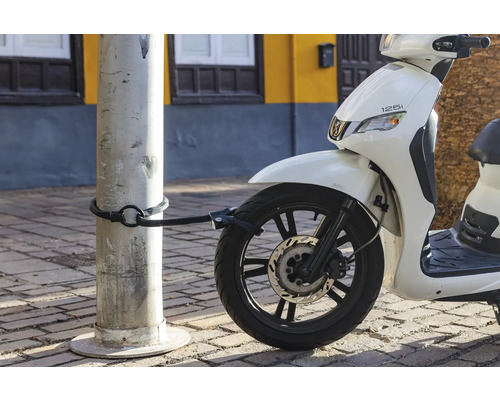 Scooter blanc avec antivol à câble fixé à un poteau