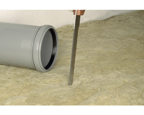 Tuyau en plastique gris et une scie coupant de la laine isolante.