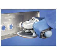 Meuleuse d'angle ponçant un profilé métallique avec un disque abrasif rotatif.