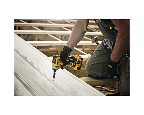 Un artisan fixe une plaque métallique avec une visseuse à percussion sans fil Dewalt.
