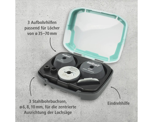 Kit de centrage pour scie cloche Wolfcraft avec trois guides de perçage, trois douilles de perçage en acier et une aide à l'enfoncement dans une boîte.