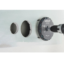 Scie cloche Wolfcraft avec perceuse perçant des trous dans un mur.