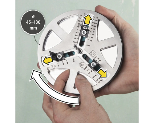 Un outil permettant de marquer avec précision des trous de forage d'un diamètre de 45 à 130 millimètres est tenu par deux mains.