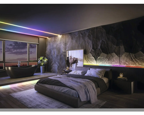 Chambre et salle de bain modernes avec éclairage LED intelligent, mur en pierre sombre, lit double et baignoire îlot.