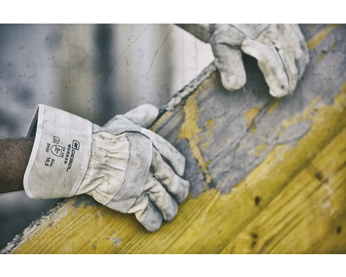 Ein Arbeiter trägt Gebol Worker Schutzhandschuhe bei der Arbeit mit einem Holzrahmen.