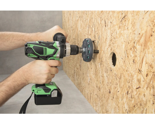 Une personne perce un trou dans une plaque de bois avec une perceuse-visseuse sans fil.