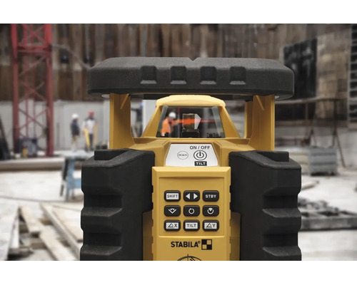 Laser rotatif Stabila sur un chantier avec panneau de commande et tête laser.