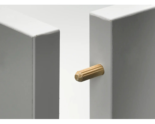 Tourillon en bois pour l'assemblage de deux panneaux de meubles blancs.