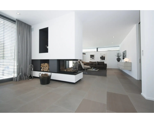 Salon moderne avec de grands carreaux de sol et une cheminée d'angle vitrée.
