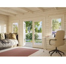 Intérieur d'un abri de jardin en bois lumineux avec bureau, canapé et vue sur le jardin à travers de grandes portes vitrées.