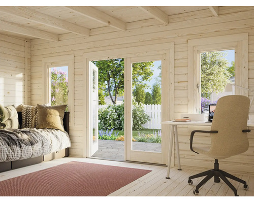 Intérieur d'un abri de jardin en bois lumineux avec bureau, canapé et vue sur le jardin à travers de grandes portes vitrées.