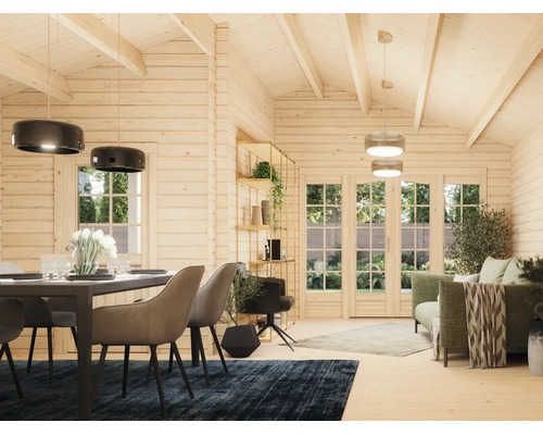 Intérieur lumineux d'un abri de jardin en bois avec coin repas, salon et grandes baies vitrées sur le jardin.