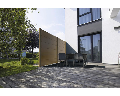 Pare-vue en panneaux sur une terrasse en bois devant une maison moderne avec des meubles de jardin et un jardin.