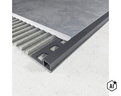 Exemple d'application d'un profilé pour carrelage carré en anthracite lors de la pose d'un carreau dans la colle. (Image AI modified or generated)