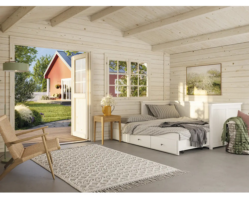 Innenansicht eines hellen, wohnlich eingerichteten Gartenhauses aus Holz mit Daybed, Sessel und Blick durch die openen Tür in den Garten.