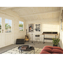 Une maison en bois chaleureuse avec une salle de musique équipée d une guitare, d un clavier, d un ampli, d un tabouret, table et fauteuil.