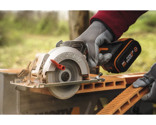 Scie Worx coupant une brique