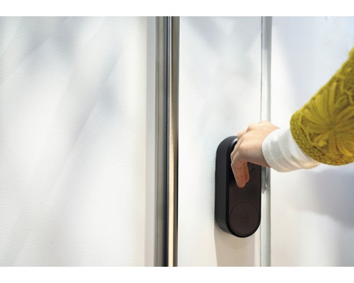 Hand betätigt ein elektronisches Türschloss an einer Tür