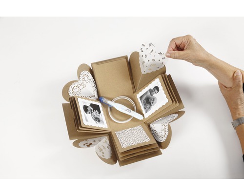 Boîte à explosion avec photos, bâton de colle et décorations en papier