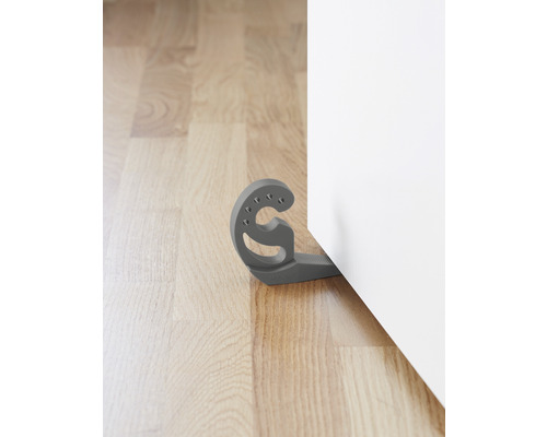 Grauer Türstopper aus Kunststoff vor einer Tür