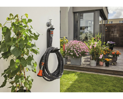 Scène de jardin avec plantes, terrasse et tuyau d''arrosage enroulé avec support mural