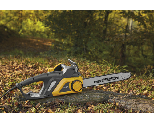 Tronçonneuse électrique Stiga sur une bûche à l''extérieur