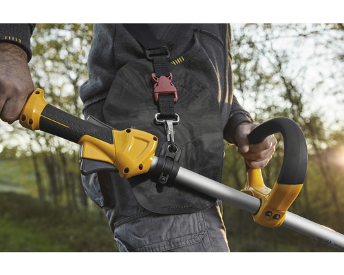 Person mit Trimmer mit Tragegurt für Gartenarbeiten