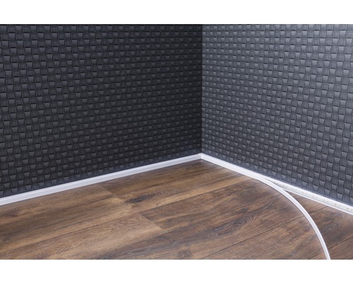 Raumecke mit dunkler Wandverkleidung, Laminatboden und weißen Fußleisten