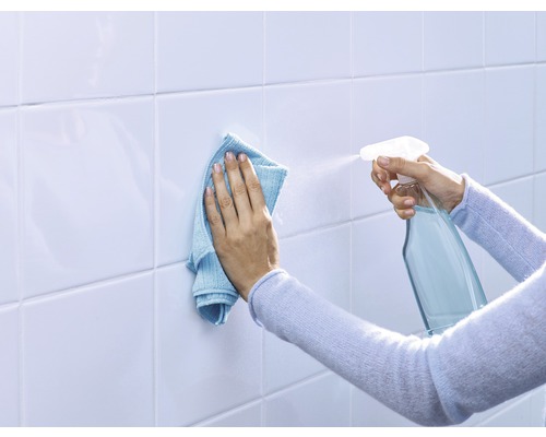 Reinigung von Fliesen mit Sprühflasche und Tuch