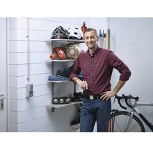 Cave organisée avec des étagères, un vélo et des articles de sport.