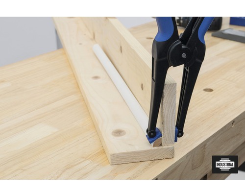 Tasseaux de bois avec serre-joint à une main et barre ronde sur un établi