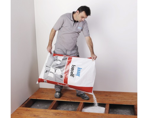 Un homme verse de l''isolation soufflée Knauf Isoself sur un plancher en bois