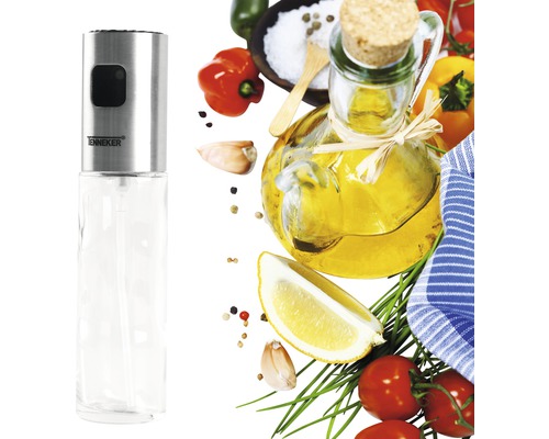Ölsprüher aus Edelstahl und Glas mit verschiedenen Zutaten im Hintergrund