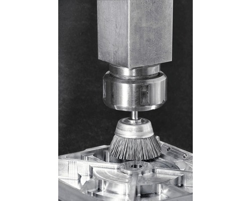 Drahtbürste an Werkzeugmaschine bei der Bearbeitung eines Werkstücks.