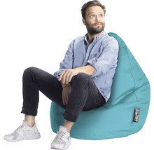 Homme assis sur un pouf turquoise