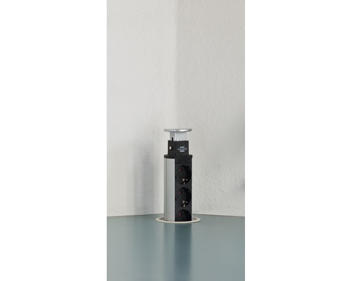 Bloc multiprise escamotable avec trois prises sur un plateau de table
