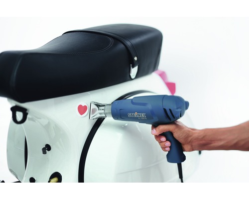 Pistolet thermique lors de l''application d''un autocollant sur un scooter