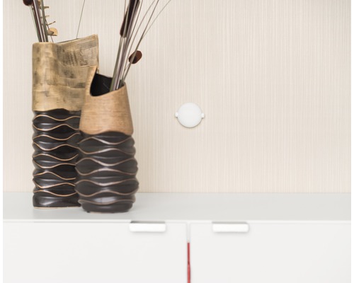 Deux vases décoratifs et une applique murale ronde sur le mur