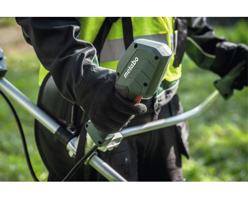 Person hält den Griff eines Rasentrimmers der Marke Metabo.