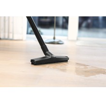 Embout d''un aspirateur eau et poussière sur un parquet
